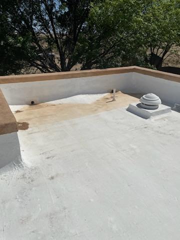 Before: Damaged flat roof section